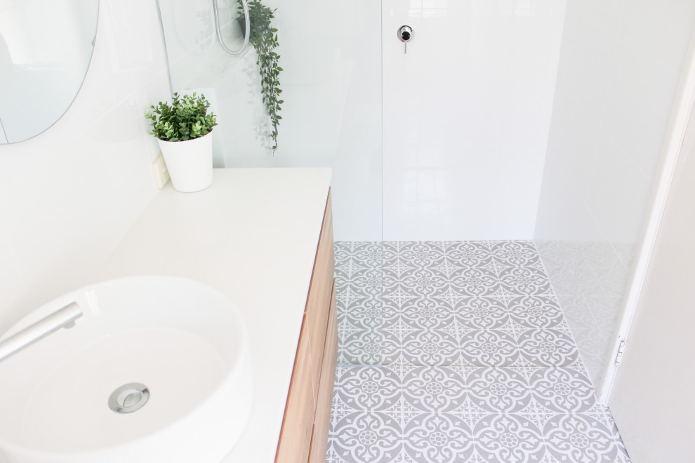 Bathroom - mid-sized 3/4 white tile and ceramic tile mosaic tile floor, multicolored floor and single-sink bathroom idea in Perth with flat-panel cabinets, light wood cabinets, a one-piece toilet, white walls, a vessel sink, quartz countertops, white countertops and a floating vanity