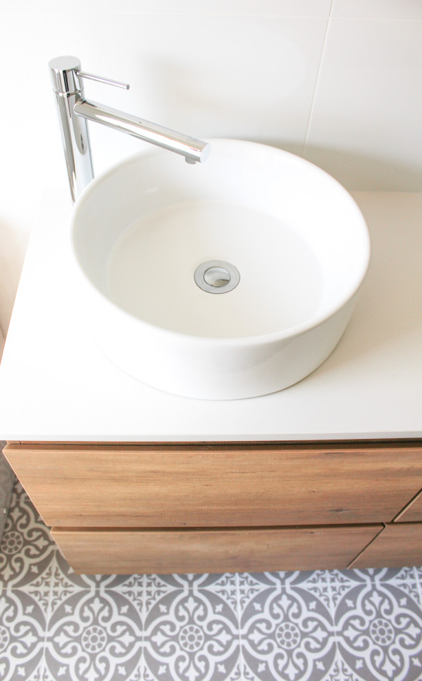 Example of a mid-sized 3/4 white tile and ceramic tile mosaic tile floor, multicolored floor and single-sink bathroom design in Perth with flat-panel cabinets, light wood cabinets, a one-piece toilet, white walls, a vessel sink, quartz countertops, white countertops and a floating vanity