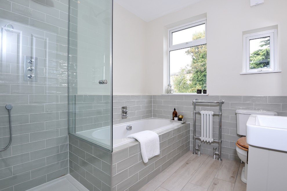 Inspiration for a medium sized modern family bathroom in London with shaker cabinets, grey cabinets, a built-in bath, a corner shower, a two-piece toilet, green tiles, ceramic tiles, beige walls, ceramic flooring and a console sink.