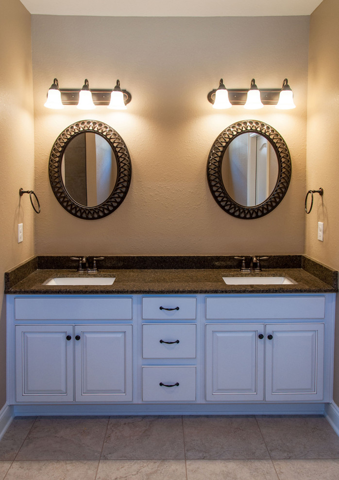 Large southwest master ceramic tile bathroom photo in Miami with raised-panel cabinets, white cabinets, granite countertops, a two-piece toilet, beige walls and an undermount sink