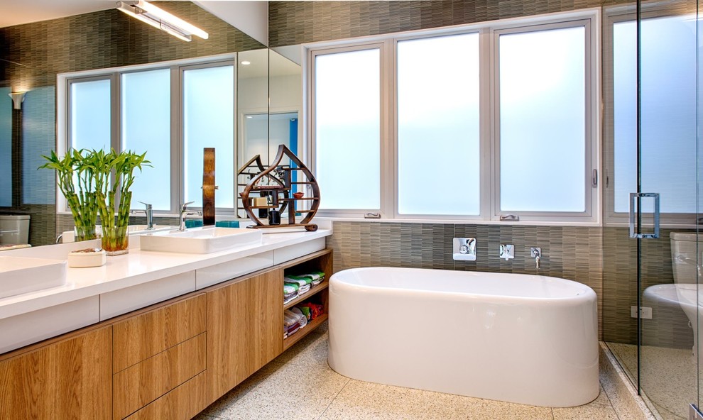 Contemporary bathroom in Houston with a freestanding bath and a vessel sink.