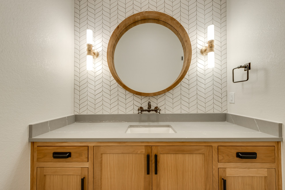 Inspiration for a mid-sized transitional 3/4 white tile and ceramic tile cement tile floor and multicolored floor bathroom remodel in Dallas with raised-panel cabinets, medium tone wood cabinets, a two-piece toilet, beige walls, an undermount sink, quartzite countertops and brown countertops