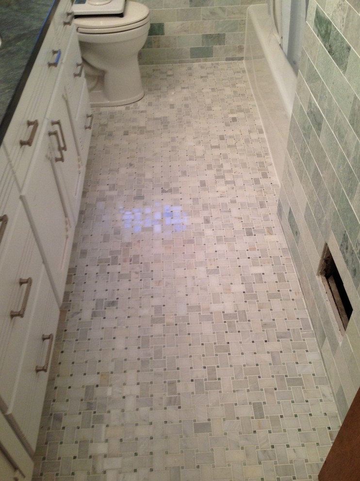 This is an example of a medium sized ensuite bathroom in Boston with flat-panel cabinets, white cabinets, an alcove bath, a shower/bath combination, a two-piece toilet, grey tiles, metro tiles, blue walls, mosaic tile flooring, a submerged sink, engineered stone worktops, grey floors and a shower curtain.