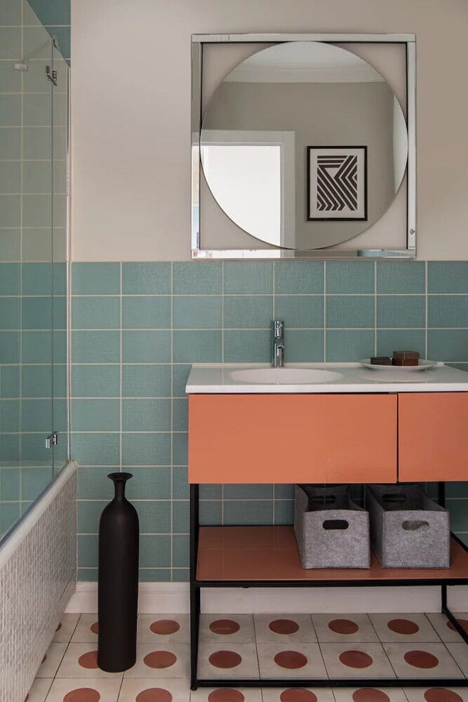 Idéer för att renovera ett mellanstort funkis vit vitt en-suite badrum, med släta luckor, orange skåp, ett undermonterat badkar, en dusch/badkar-kombination, en vägghängd toalettstol, blå kakel, keramikplattor, beige väggar, cementgolv, ett konsol handfat, bänkskiva i akrylsten, orange golv och dusch med duschdraperi