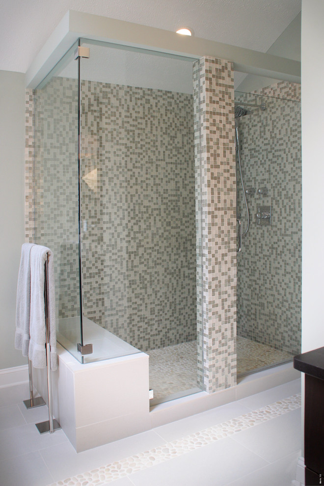 This is an example of a medium sized modern ensuite bathroom in Cleveland with flat-panel cabinets, brown cabinets, a freestanding bath, a walk-in shower, a one-piece toilet, green tiles, glass sheet walls, green walls, porcelain flooring, a vessel sink, soapstone worktops, grey floors and a hinged door.