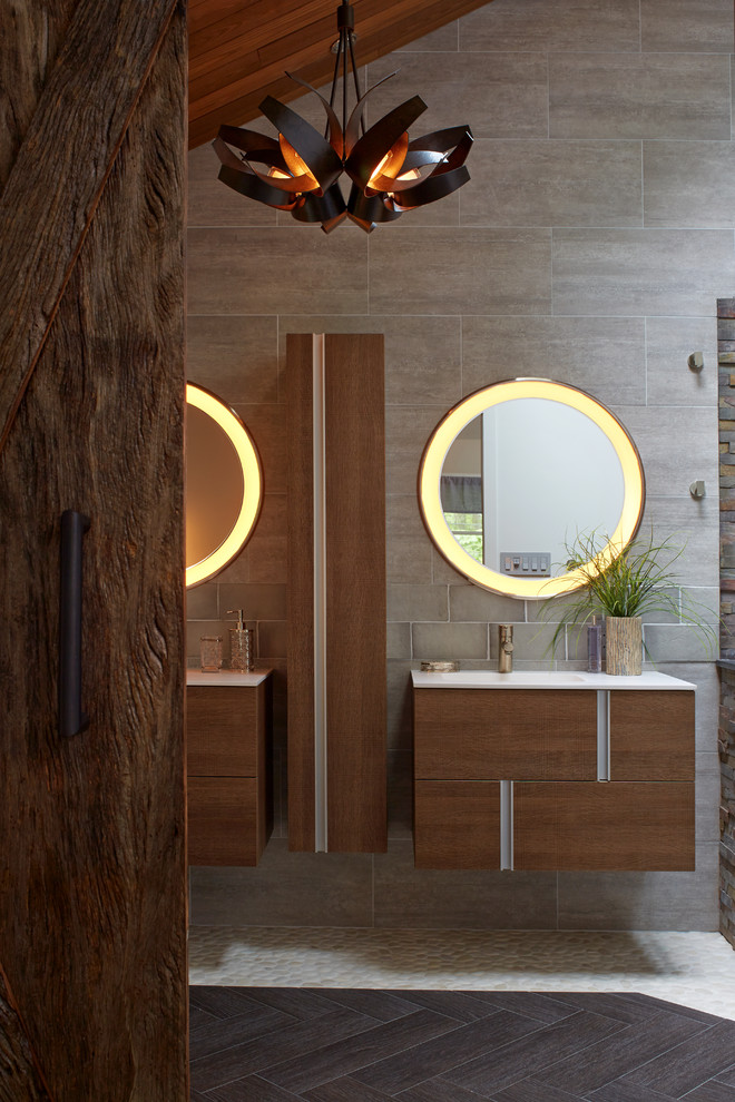 Inspiration for a large contemporary ensuite bathroom in New York with flat-panel cabinets, dark wood cabinets, a wall mounted toilet, beige tiles, grey tiles, multi-coloured tiles, ceramic flooring, a console sink and a hinged door.
