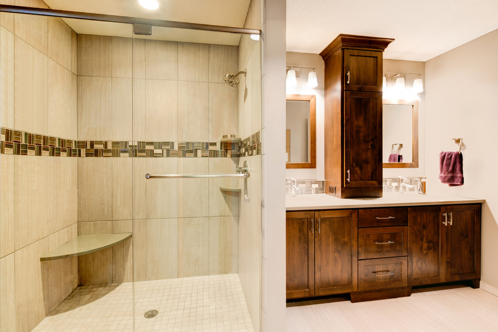 Inspiration for a mid-sized transitional 3/4 beige tile and porcelain tile beige floor and porcelain tile alcove shower remodel in Minneapolis with shaker cabinets, dark wood cabinets, beige walls, a hinged shower door and an undermount sink