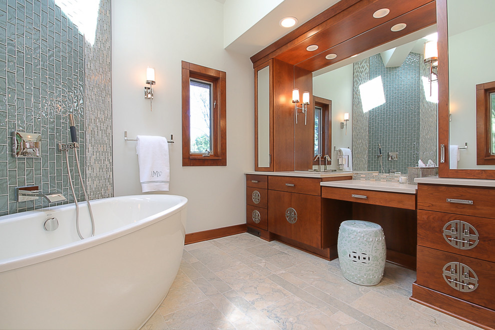 Example of a large master blue tile and glass tile marble floor bathroom design in Chicago with flat-panel cabinets, medium tone wood cabinets, white walls, an undermount sink and solid surface countertops