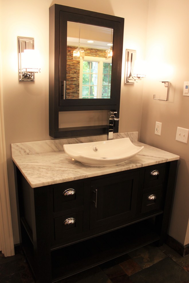 Medium sized classic ensuite bathroom in Indianapolis with freestanding cabinets, dark wood cabinets, a freestanding bath, a double shower, a bidet, multi-coloured tiles, stone tiles, grey walls, slate flooring, a vessel sink and marble worktops.