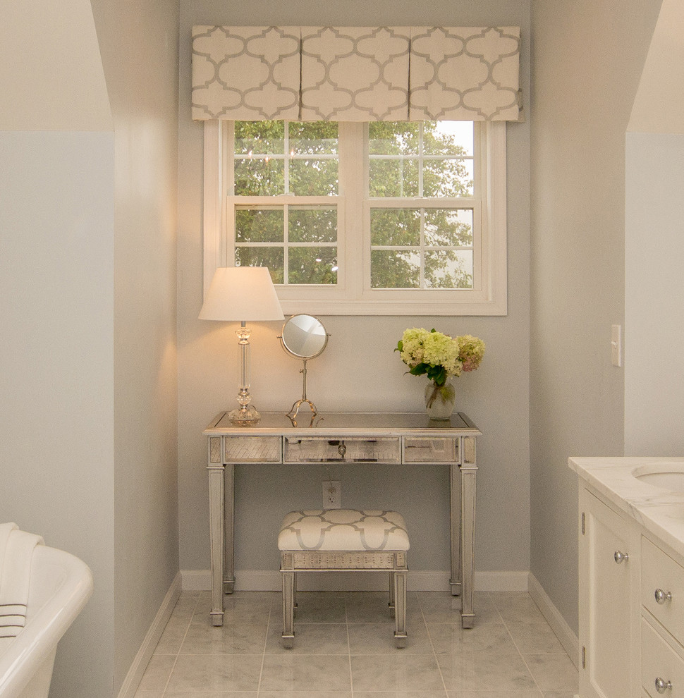 This is an example of a large traditional ensuite bathroom in Philadelphia with freestanding cabinets, white cabinets, a claw-foot bath, a one-piece toilet, mosaic tiles, grey walls, marble flooring, a submerged sink, marble worktops, grey tiles and a corner shower.