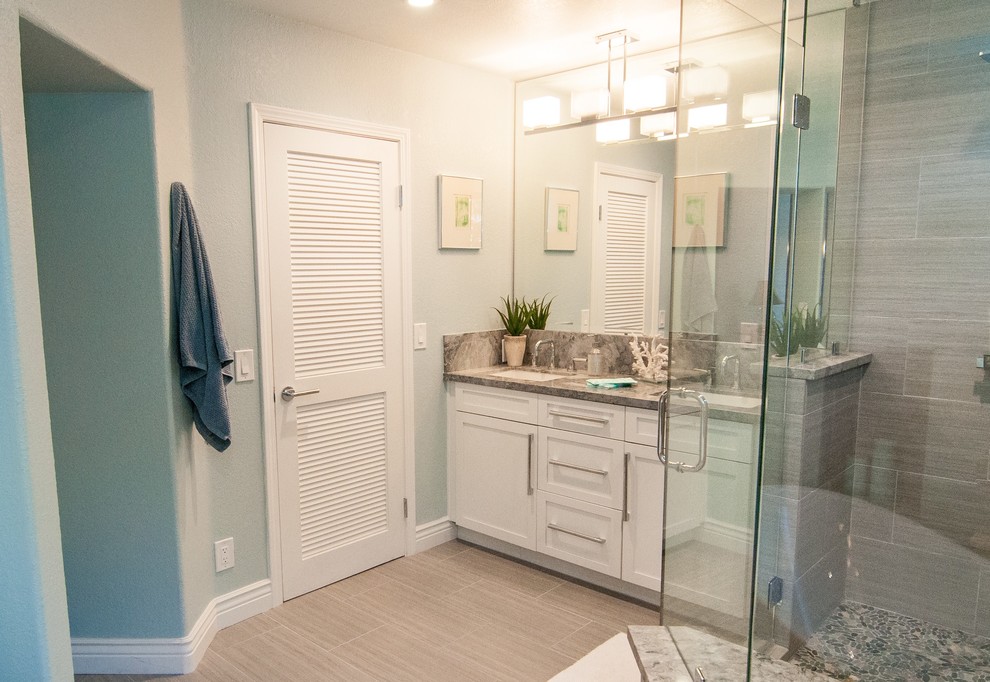 Large beach style master gray tile bathroom photo in San Diego with shaker cabinets, white cabinets, blue walls and an undermount sink