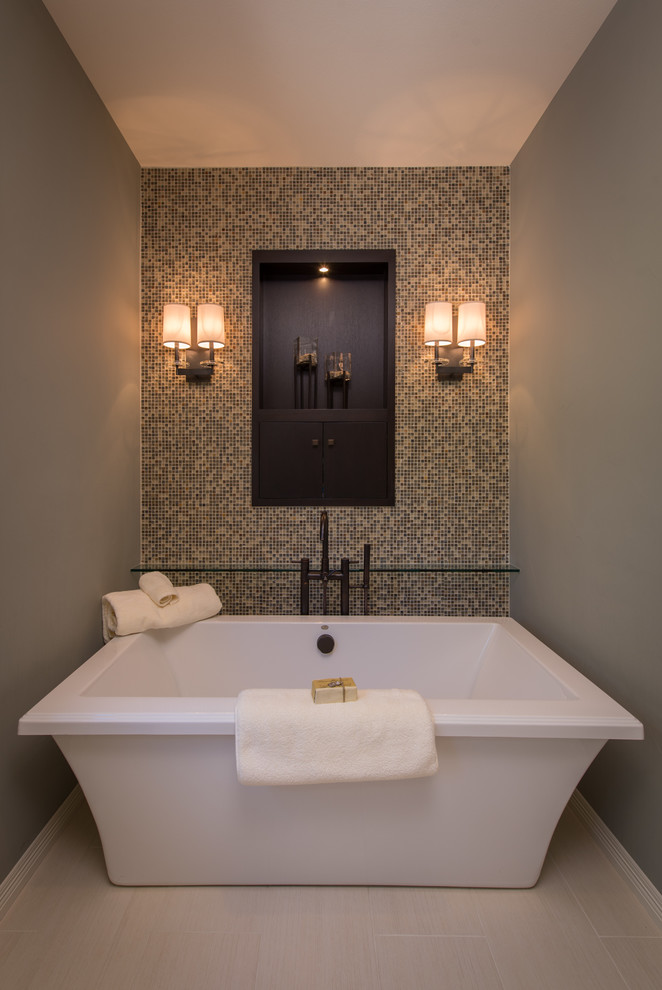 This is an example of a traditional bathroom in Denver with a freestanding bath, grey tiles and mosaic tiles.