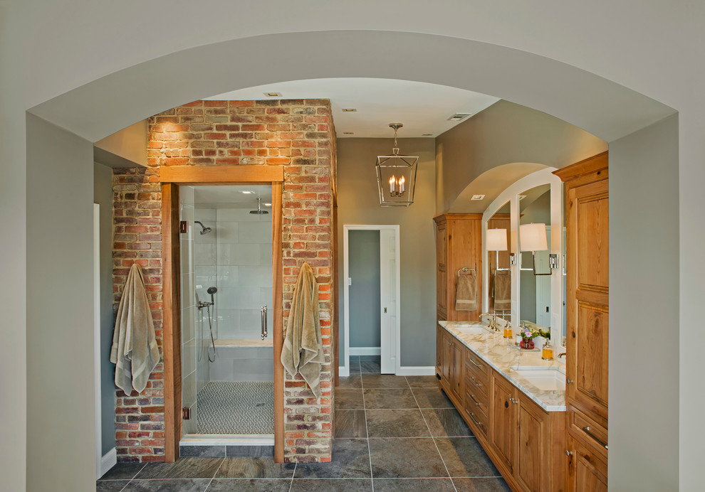 Exemple d'une grande salle de bain principale chic en bois brun avec un lavabo encastré, un placard avec porte à panneau surélevé, un plan de toilette en marbre, un carrelage gris et des carreaux de porcelaine.