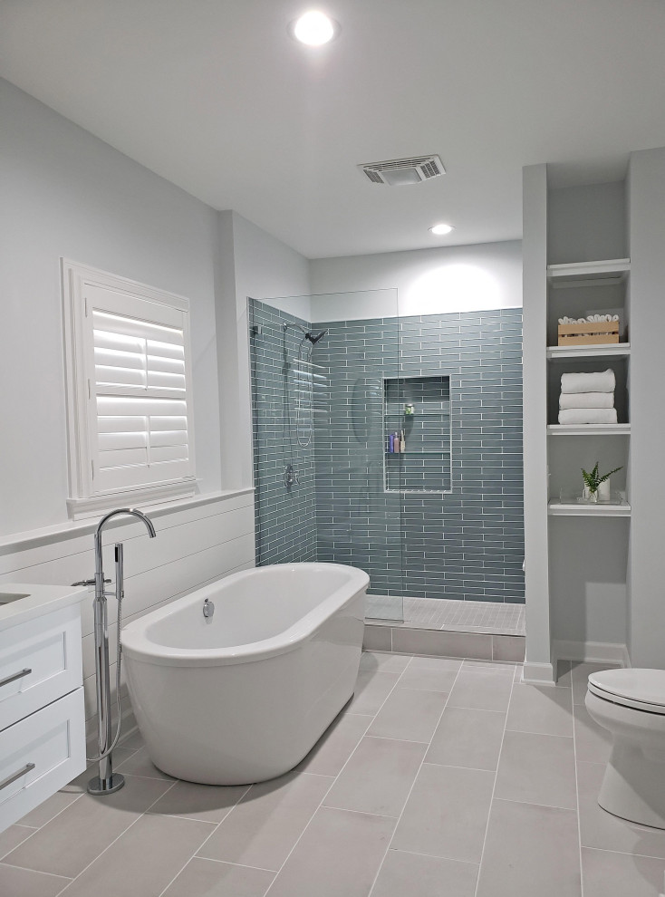 Large contemporary ensuite bathroom in Nashville with shaker cabinets, white cabinets, a freestanding bath, an alcove shower, green tiles, glass tiles, white walls, porcelain flooring, a submerged sink, engineered stone worktops, grey floors, an open shower, white worktops, a wall niche, double sinks, tongue and groove walls and a floating vanity unit.