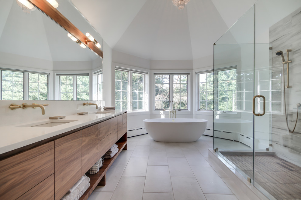 Large contemporary ensuite bathroom in Philadelphia with a submerged sink, flat-panel cabinets, light wood cabinets, a freestanding bath, an alcove shower, white walls, a two-piece toilet, white tiles, stone slabs, slate flooring, quartz worktops, grey floors and a hinged door.