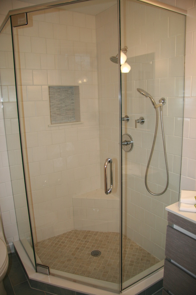 Corner shower - small contemporary master blue tile and mosaic tile ceramic tile corner shower idea in DC Metro with an integrated sink, furniture-like cabinets, gray cabinets, solid surface countertops, a two-piece toilet and black walls