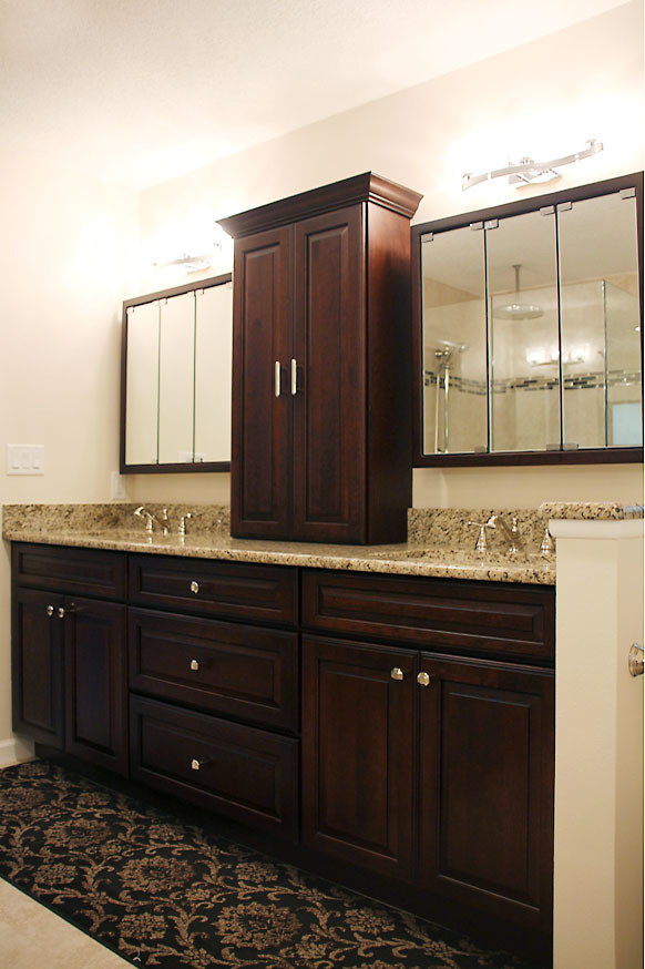 Example of a mid-sized classic master beige tile and porcelain tile porcelain tile bathroom design in Tampa with an undermount sink, raised-panel cabinets, dark wood cabinets, granite countertops, a one-piece toilet and beige walls