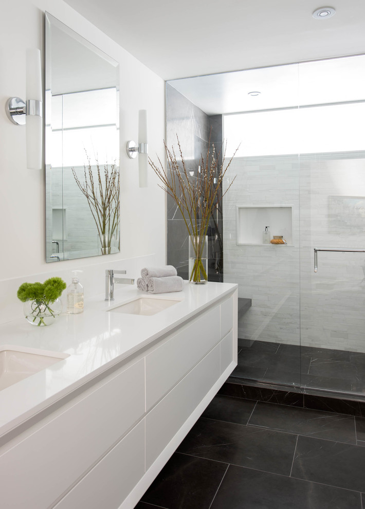 Design ideas for a medium sized contemporary ensuite bathroom in Toronto with a submerged sink, flat-panel cabinets, white cabinets, engineered stone worktops, an alcove shower, grey tiles, stone tiles, white walls and marble flooring.