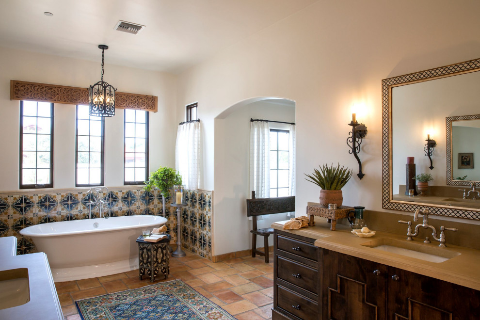 Example of a large tuscan master multicolored tile and terra-cotta tile terra-cotta tile and double-sink bathroom design in Phoenix with raised-panel cabinets, brown cabinets, white walls, an undermount sink, concrete countertops, a hinged shower door and a built-in vanity