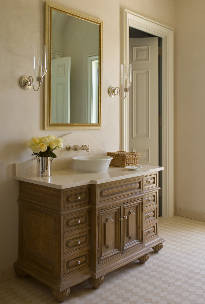 Design ideas for a large ensuite bathroom in Atlanta with recessed-panel cabinets, dark wood cabinets, beige tiles, stone tiles, beige walls, porcelain flooring, a pedestal sink and marble worktops.