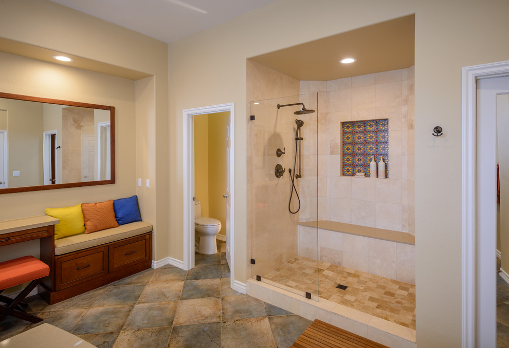 This is an example of a large mediterranean ensuite bathroom in Los Angeles with beige walls, porcelain flooring, freestanding cabinets, a built-in bath, an alcove shower, a one-piece toilet, a submerged sink and quartz worktops.