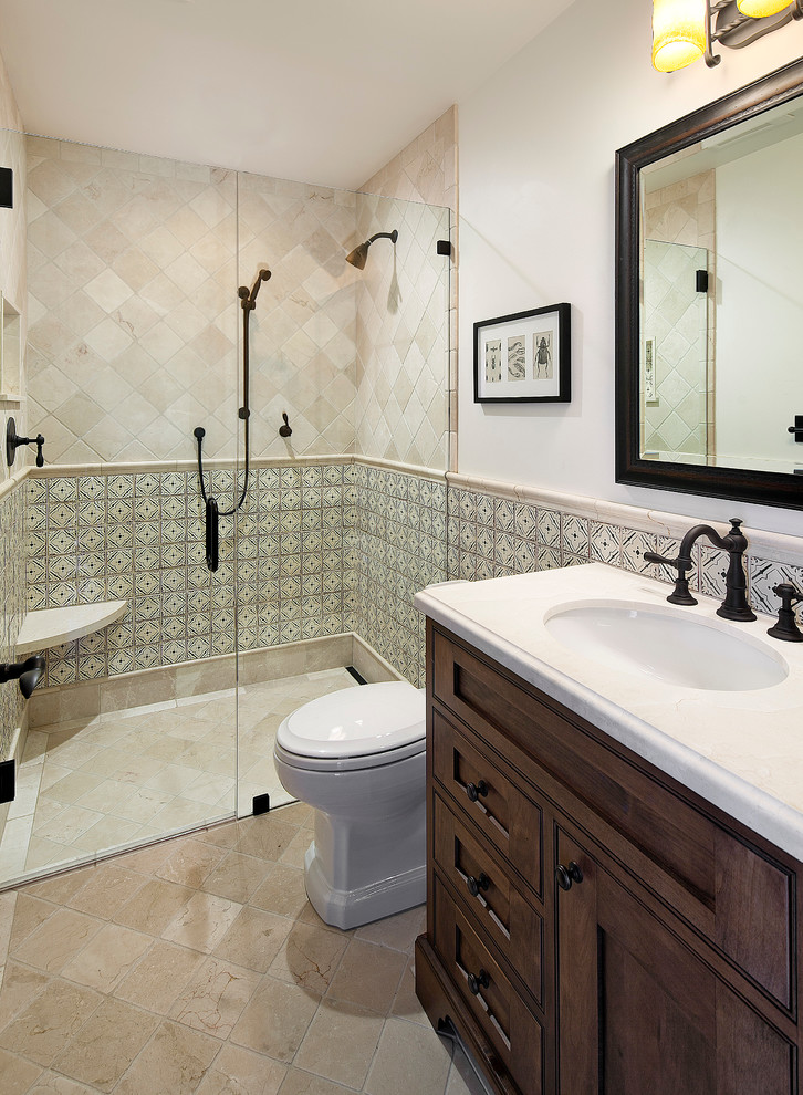 Design ideas for a medium sized mediterranean bathroom in Santa Barbara with a submerged sink, recessed-panel cabinets, a built-in shower, a two-piece toilet, beige tiles, ceramic tiles and beige walls.