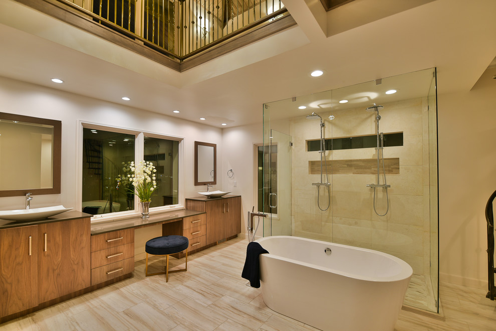Photo of a large modern ensuite bathroom in Salt Lake City with flat-panel cabinets, dark wood cabinets, a freestanding bath, a double shower, white tiles, limestone tiles, white walls, marble flooring, engineered stone worktops, white floors and a hinged door.