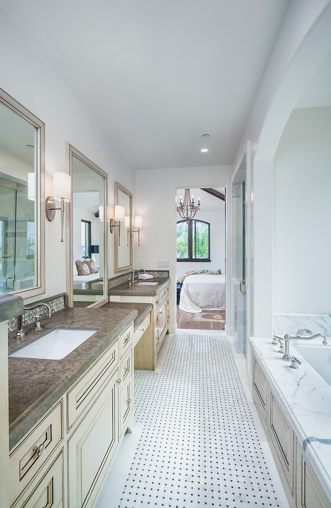 Example of a transitional master bathroom design in Los Angeles with an undermount sink, recessed-panel cabinets, beige cabinets, an undermount tub and white walls
