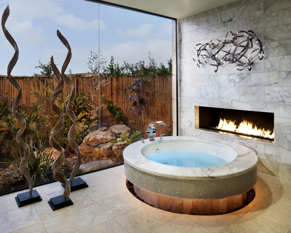 Example of a trendy beige tile bathroom design in Austin with a hot tub