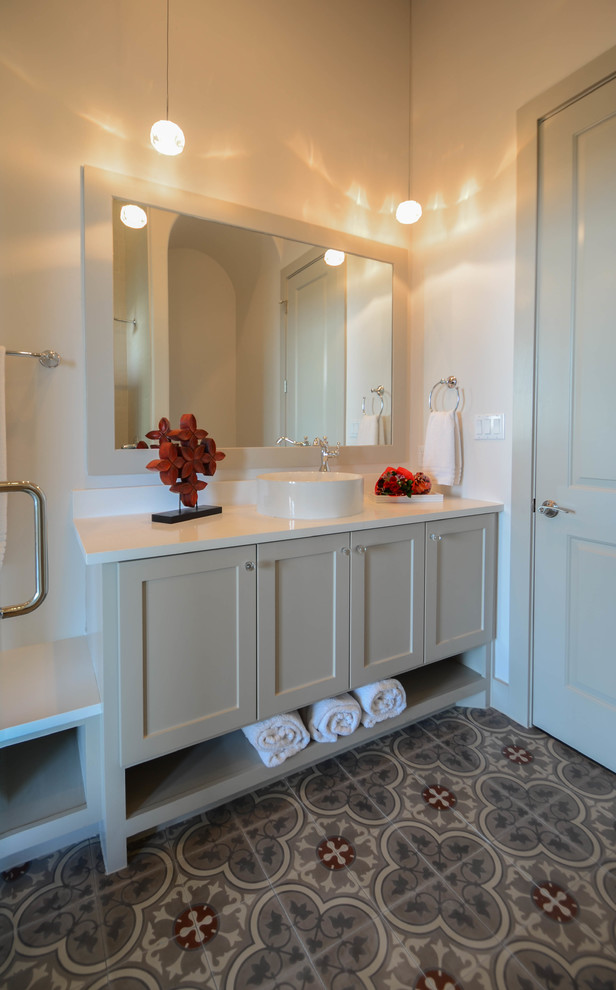 Photo of a large mediterranean family bathroom in Austin with shaker cabinets, white cabinets, a built-in shower, a two-piece toilet, grey tiles, cement tiles, white walls, cement flooring, a vessel sink, engineered stone worktops, grey floors and a hinged door.