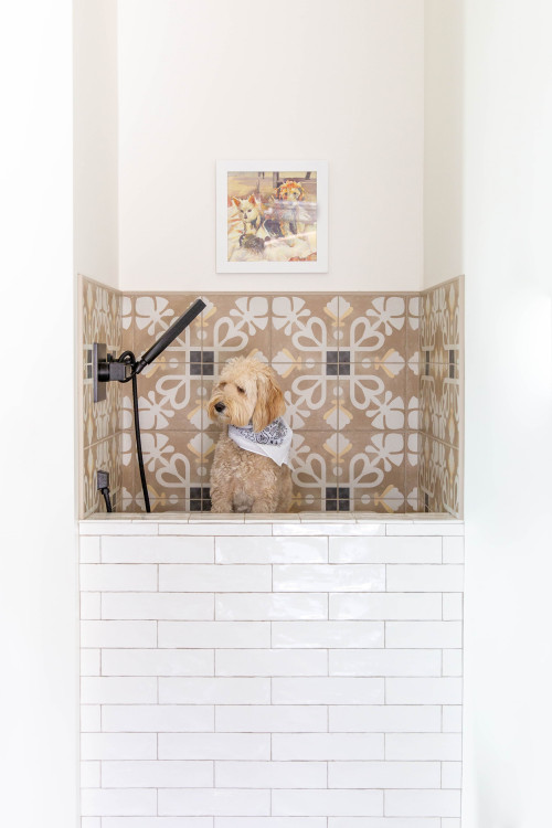 Raised dog bath with fancy tile work and a dog sitting in the bath. 