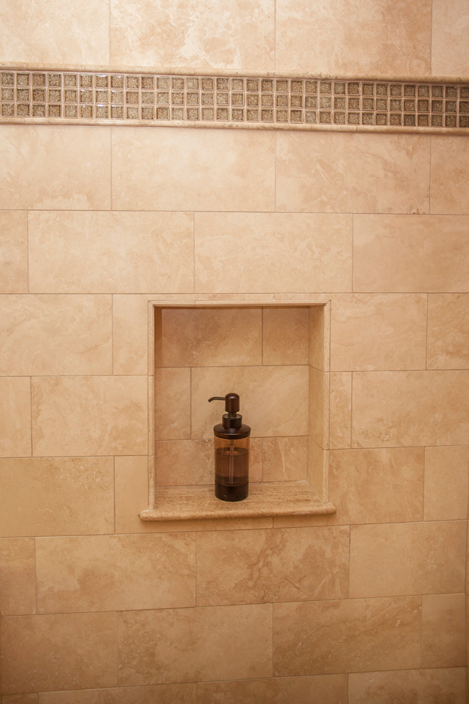 Double shower - large mediterranean master beige tile and travertine tile travertine floor double shower idea in Los Angeles with recessed-panel cabinets, dark wood cabinets, an undermount tub, a bidet, beige walls, an undermount sink, limestone countertops and a hinged shower door
