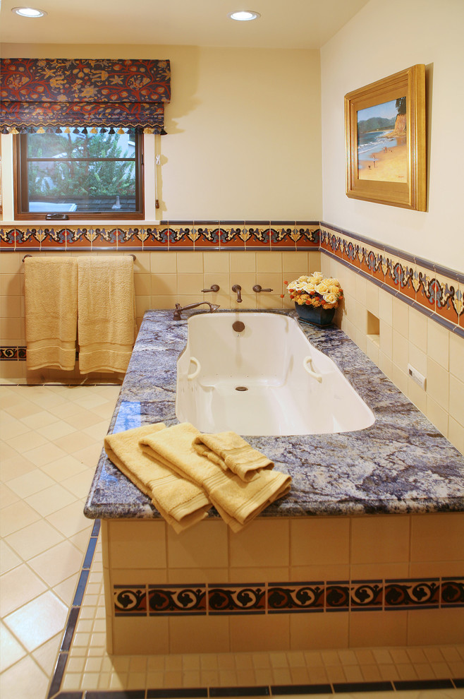 This is an example of a large mediterranean ensuite bathroom in Los Angeles with shaker cabinets, granite worktops, a submerged bath, yellow tiles, ceramic tiles, ceramic flooring and white walls.