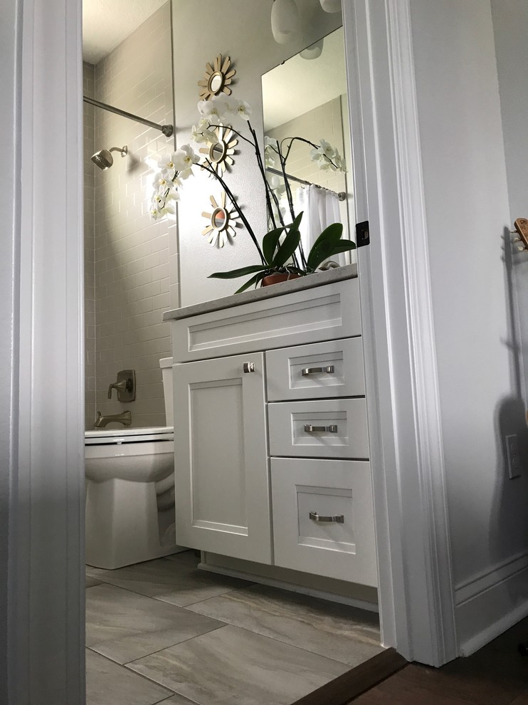 Idéer för att renovera ett litet funkis badrum, med luckor med infälld panel, vita skåp, en toalettstol med separat cisternkåpa, grå kakel, tunnelbanekakel, grå väggar, klinkergolv i keramik, ett undermonterad handfat, granitbänkskiva, grått golv och dusch med duschdraperi