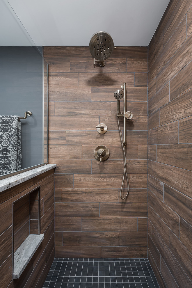 Photo of a large classic shower room bathroom in Chicago with an alcove shower, brown tiles, grey floors, a hinged door, recessed-panel cabinets, blue cabinets, a two-piece toilet, porcelain tiles, blue walls, ceramic flooring, a submerged sink, granite worktops and grey worktops.