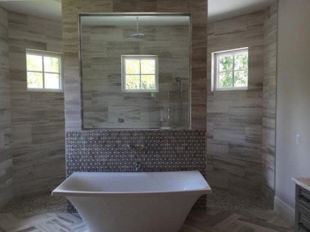 Inspiration for a large classic ensuite bathroom in Miami with shaker cabinets, grey cabinets, a freestanding bath, a walk-in shower, a one-piece toilet, grey tiles, stone tiles, grey walls, limestone flooring, a submerged sink and quartz worktops.
