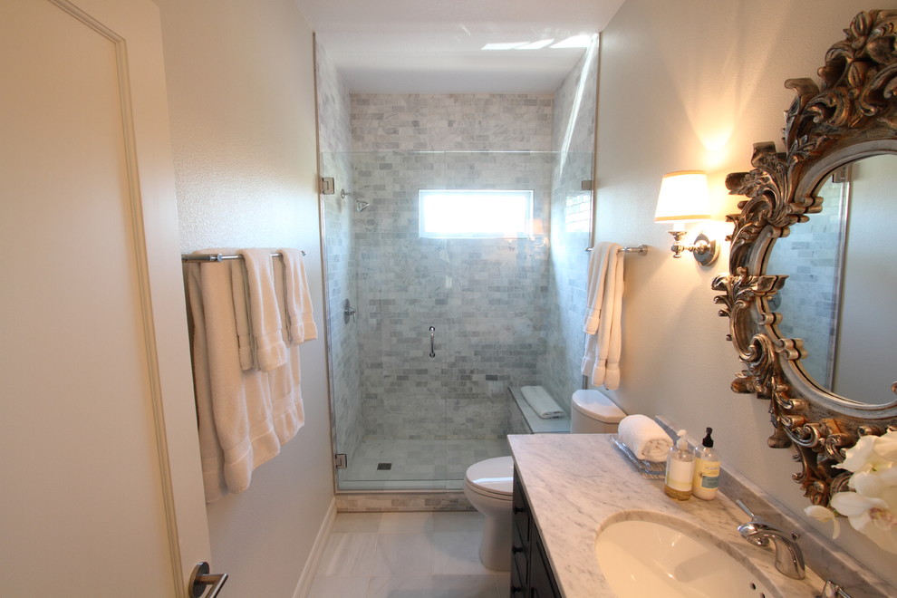 Idee per una piccola stanza da bagno con doccia minimal con lavabo sottopiano, ante in stile shaker, ante in legno bruno, top in marmo, WC a due pezzi, piastrelle bianche, piastrelle in pietra, pareti beige e pavimento in marmo