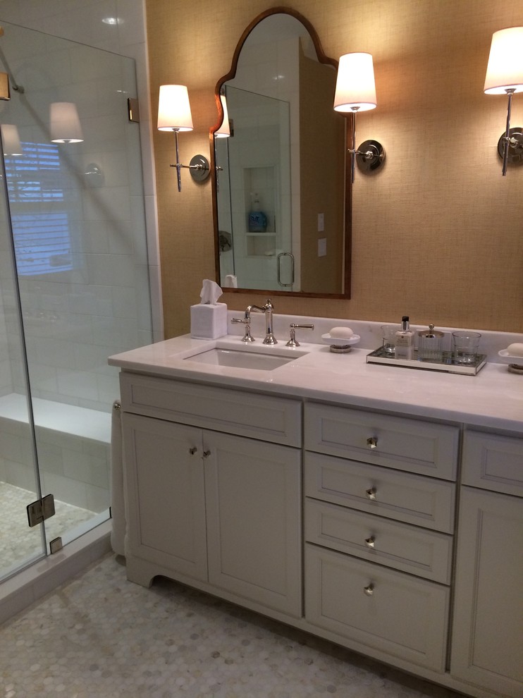 Large nautical ensuite bathroom in Boston with a submerged sink, recessed-panel cabinets, white cabinets, marble worktops, a walk-in shower, a one-piece toilet, white tiles, metro tiles, yellow walls and marble flooring.