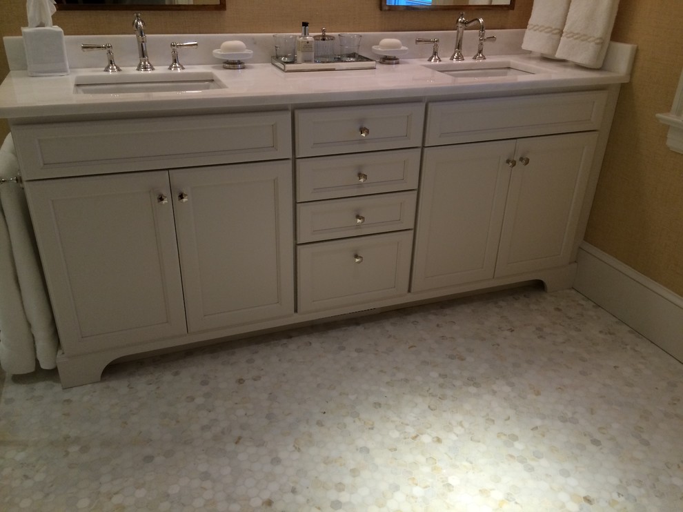 This is an example of a large nautical ensuite bathroom in Boston with a submerged sink, recessed-panel cabinets, white cabinets, marble worktops, a walk-in shower, a one-piece toilet, white tiles, metro tiles, yellow walls and marble flooring.