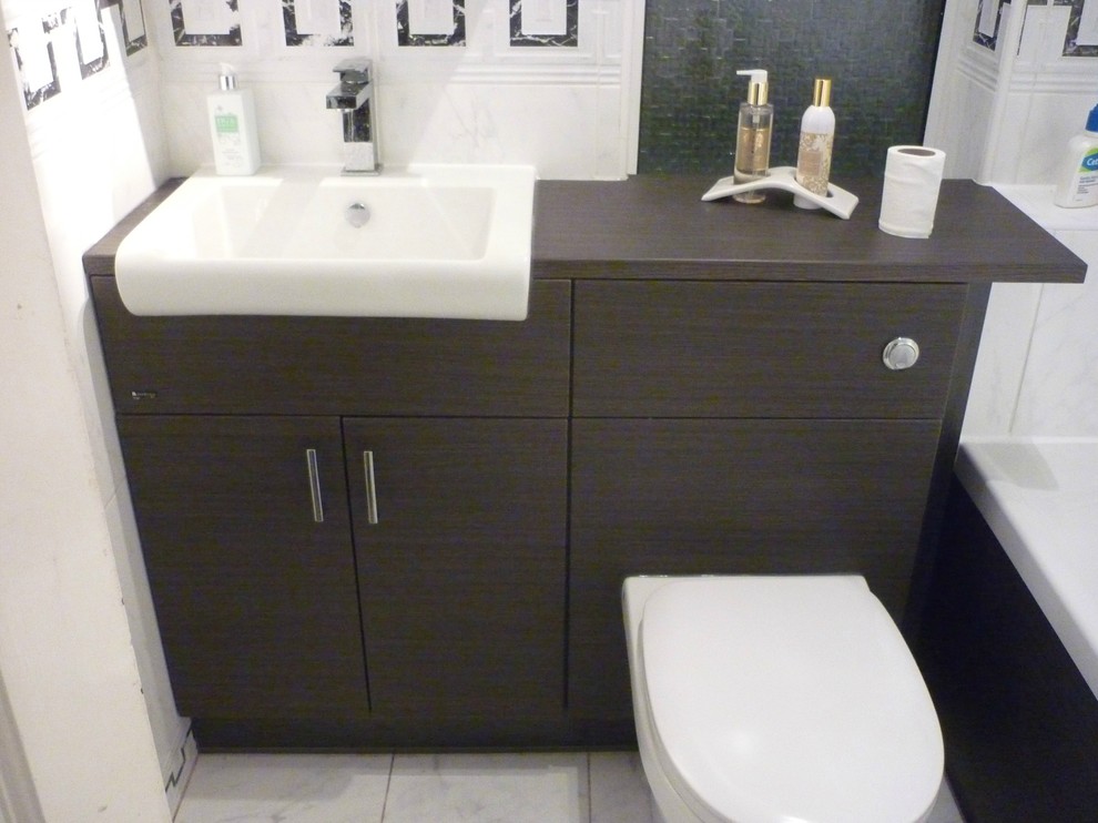 This is an example of a contemporary family bathroom in Other with a freestanding bath and stone tiles.