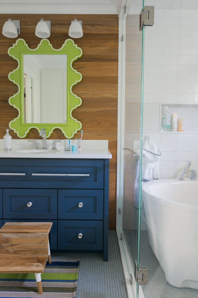 Mid-sized transitional kids' white tile and ceramic tile ceramic tile and blue floor bathroom photo in New York with flat-panel cabinets, blue cabinets, a two-piece toilet, white walls, an undermount sink, quartz countertops and a hinged shower door