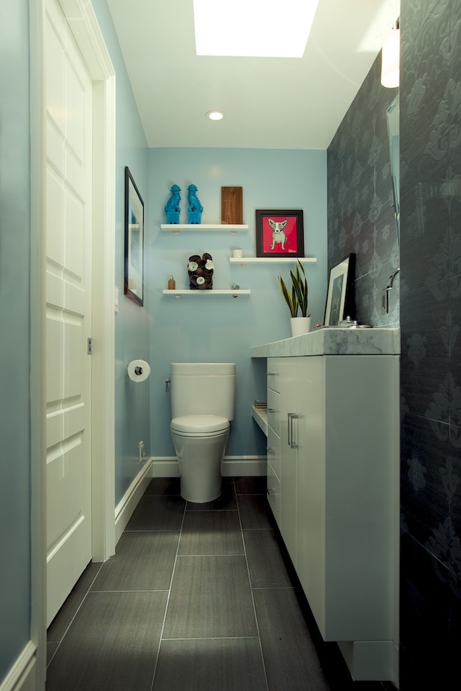 Inspiration for a small contemporary 3/4 porcelain tile and gray floor alcove shower remodel in Los Angeles with flat-panel cabinets, white cabinets, marble countertops, a two-piece toilet, blue walls, an undermount sink and a hinged shower door