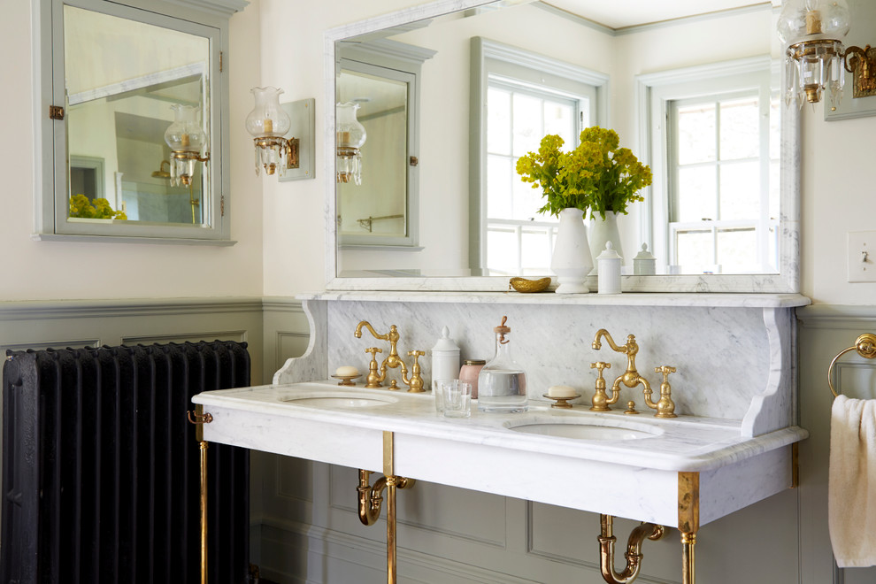 Traditional ensuite bathroom in New York with white walls and a console sink.