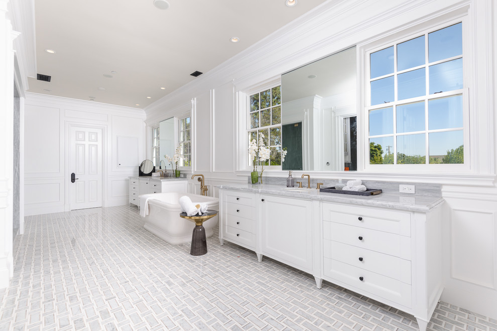 Bathroom - huge contemporary master gray tile and stone slab multicolored floor bathroom idea in Los Angeles with furniture-like cabinets, white cabinets, white walls, an undermount sink, marble countertops, a hinged shower door and gray countertops