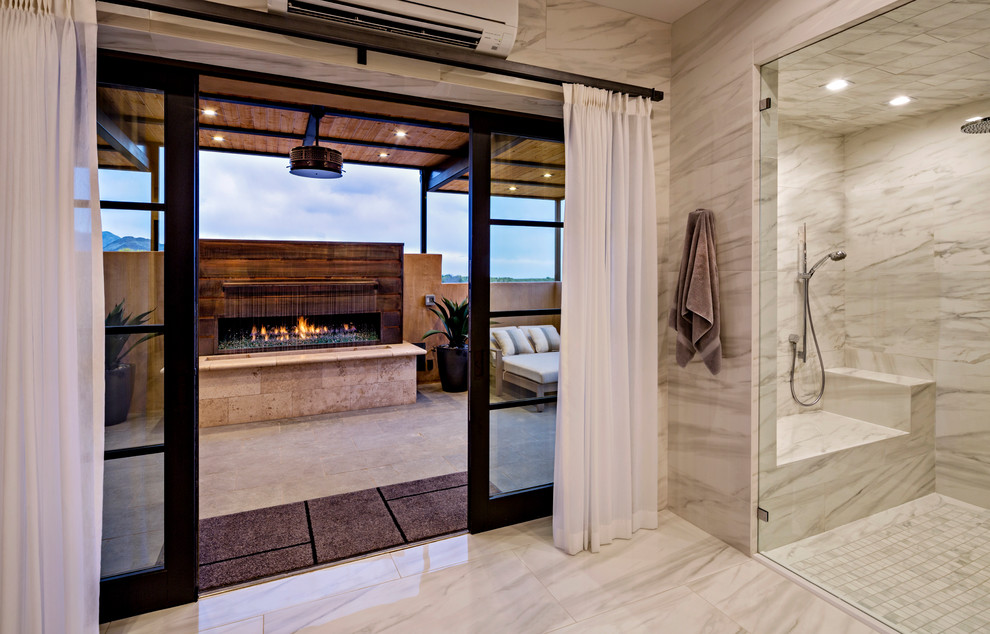 This is an example of a contemporary ensuite bathroom in Phoenix with flat-panel cabinets, medium wood cabinets, a freestanding bath, a built-in shower, grey tiles, porcelain tiles, porcelain flooring, a submerged sink, engineered stone worktops, a hinged door and white worktops.