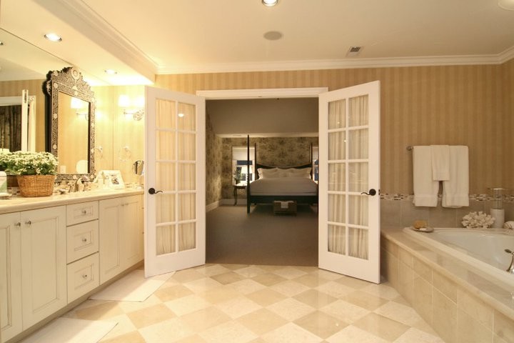Inspiration pour une grande salle de bain principale traditionnelle avec un lavabo posé, un placard avec porte à panneau surélevé, des portes de placard blanches, un plan de toilette en marbre, un bain bouillonnant, une douche ouverte, un mur beige et un sol en marbre.