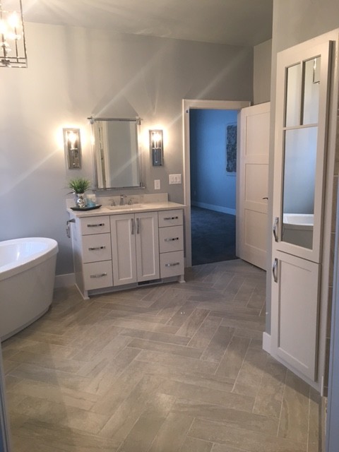 Mid-sized transitional master gray floor and porcelain tile bathroom photo in Milwaukee with white cabinets, gray walls, granite countertops, shaker cabinets and an undermount sink
