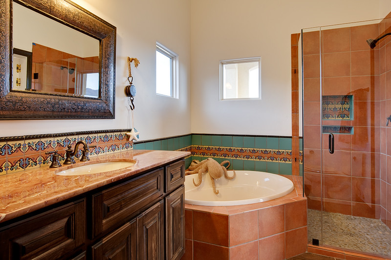Tuscan kids' porcelain tile porcelain tile bathroom photo in Albuquerque with an undermount sink, dark wood cabinets and marble countertops