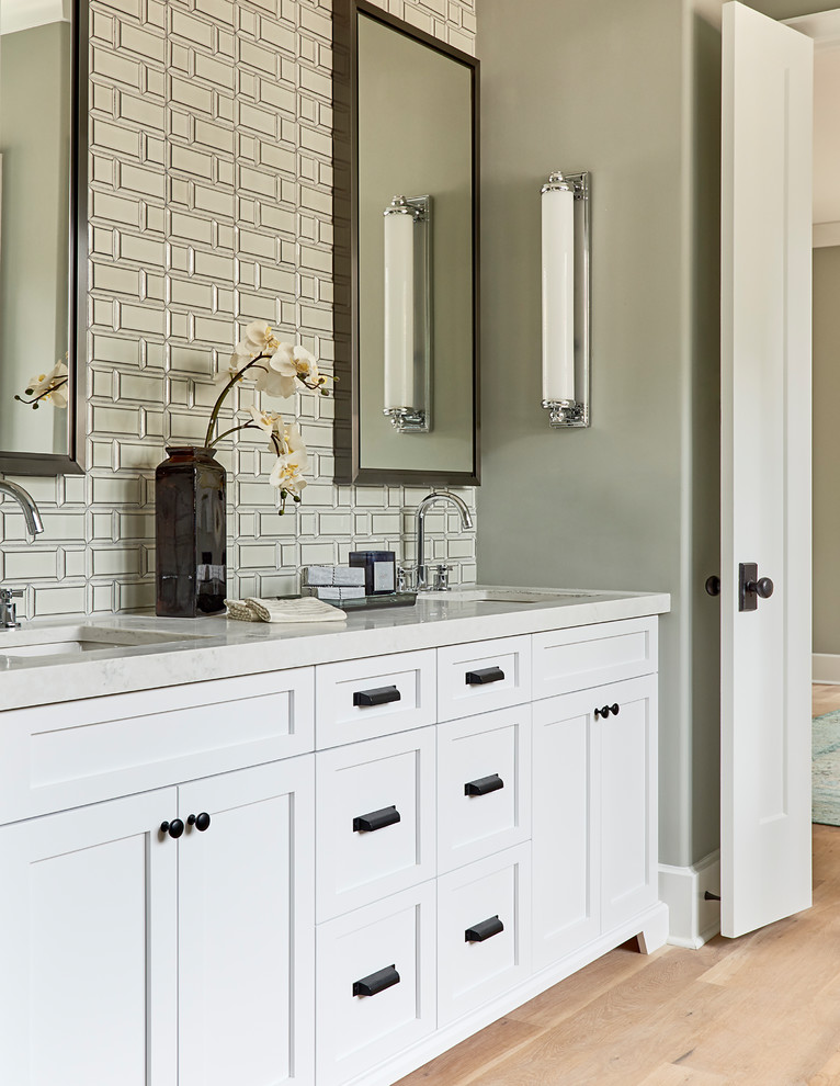 Inspiration for a transitional master metal tile light wood floor bathroom remodel in Charlotte with shaker cabinets, white cabinets, gray walls, an undermount sink and gray countertops