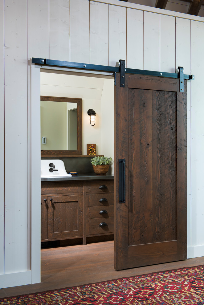 Inspiration for a large rural bathroom in Other with shaker cabinets, medium wood cabinets, beige walls, light hardwood flooring, a trough sink and zinc worktops.